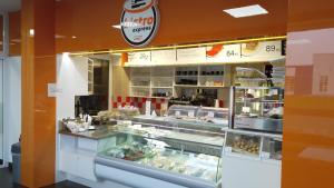 a bakery with a display case with food in it at Bed & Parking Eurobit in Hrušky