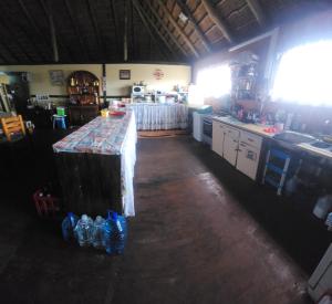 a kitchen with a counter in the middle of a room at Buffelslaagte at the Vaal in Oranjeville