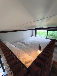 a bed in a room with a window at Tiny House Experience in Sunset Strip
