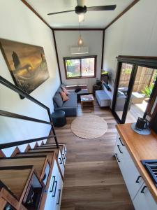 a living room with a staircase in a tiny house at Tiny House Experience in Sunset Strip