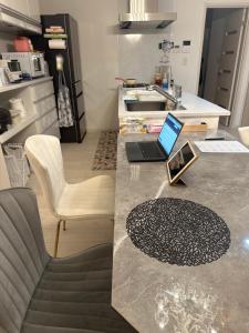 a kitchen counter with a laptop on top of it at any one in Chitose