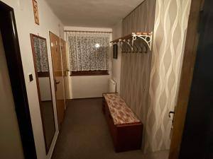 a hallway with a bench and a window at Apartmán Votoček in Rokytnice nad Jizerou