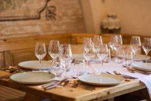 a table with wine glasses and plates on it at Cabana Plaiul Foii in Zărneşti +21 photos