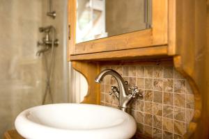 a bathroom with a sink and a medicine cabinet at Cabana Plaiul Foii in Zărneşti