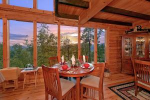 a dining room with a table and chairs in a cabin at Mountain Magic #73 in Sevierville +21 photos