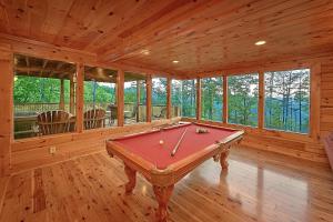 a room with a pool table in a cabin at Mountain Magic #73 in Sevierville