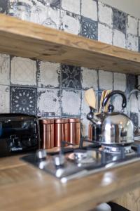 a tea kettle on a stove in a kitchen at Pine Forest Retreat Cabin in Plettenberg Bay