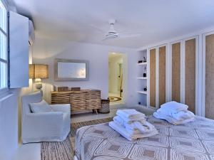 a room with a bed and a chair and a desk at Beach House Mikri Santa Maria in Kournonísi