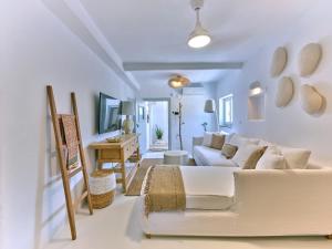 a living room with a white couch and a table at Beach House Mikri Santa Maria in Kournonísi
