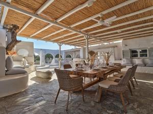 a living room with a wooden table and chairs at Beach House Mikri Santa Maria in Kournonísi