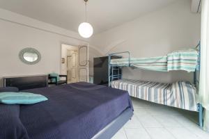 a bedroom with two bunk beds and a table at Casa Malu in Marina di Campo