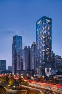 a city skyline at night with tall buildings at Vignette Collection Palm Springs Hotel Chengdu by IHG in Chengdu
