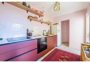 a kitchen with colorful cabinets and a sink at Goncourt42 in Nîmes +2 photos