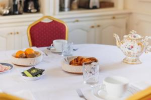 a table with a plate of bread and a tea kettle at Château Bellevue-Domaines Loron in Villié-Morgon +31 photos