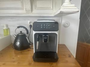 a coffee machine sitting on a table next to a tea kettle at Penzio Ostrava in Ostrava