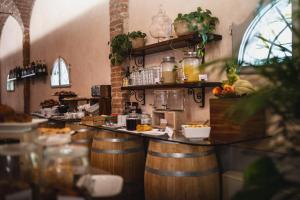 a restaurant with a bar with wooden barrels at Borgo di Colleoli Resort in Colleoli