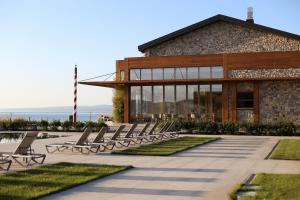 a row of lounge chairs in front of a building at İnemare Hotel in İğneada