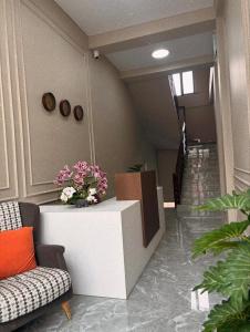 a hallway with a couch and flowers on a counter at Барыс in Almaty