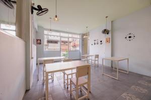 a group of tables and chairs in a room at RedDoorz near Soekarno Hatta Airport 3 in Tangerang