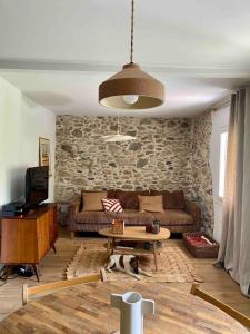 a living room with a couch and a table at La maison de Juliette in Céret