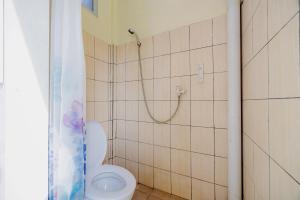 a bathroom with a toilet and a shower at RedDoorz near Soekarno Hatta Airport 3 in Tangerang +18 photos