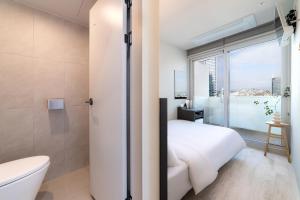 a bathroom with a bed and a toilet and a window at HiMate Dongdaemun in Seoul +87 photos