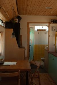 a kitchen with a wooden table and a bathroom at אוטובוס בכרם in Mitzpe Ramon +34 photos