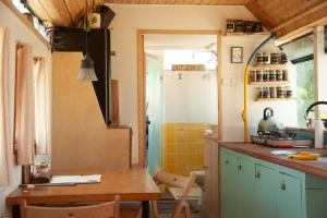 a small kitchen with a table and a sink at אוטובוס בכרם in Mitzpe Ramon