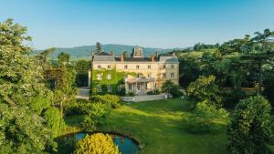 an aerial view of a large house with a pond at Château Bellevue-Domaines Loron in Villié-Morgon