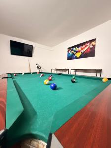a pool table with balls on it in a room at Casa Valentino in Buşteni