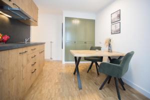 a kitchen with a table and chairs in a room at UplandParcs W3 in Winterberg