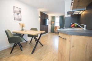 a kitchen with a table and a sink and a table at UplandParcs W3 in Winterberg