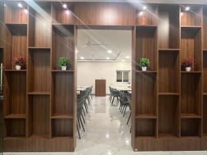 a dining room with tables and chairs and a mirror at Hotel Soham Retreat in Mahabaleshwar