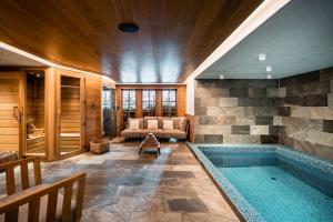 a large room with a swimming pool in a house at Chalets LA MOURRA in Val-d'Isère