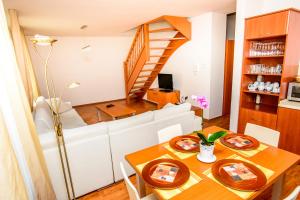 a dining room with a table and a staircase at Apartment Downtown in Žilina