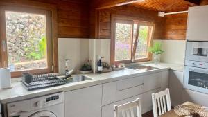 a kitchen with a sink and a stove top oven at Betenama - Rustic Hideaway with Pool & Garden in Tesbabo +43 photos