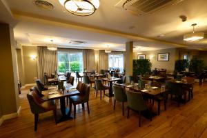 a restaurant with tables and chairs in a room at Y Seren Hotel & Restaurant in Carmarthen