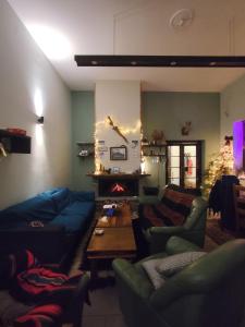 a living room with couches and a christmas tree at Χάνι Γρεβενιτίου in Grevenítion