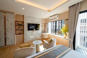 a bedroom with a bed and a living room at Bestier Hotel Hatyai in Hat Yai