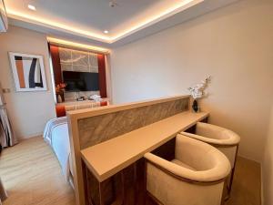 a hospital room with a desk and two chairs at Bestier Hotel Hatyai in Hat Yai