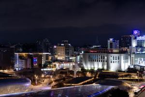 a view of a city at night with lights at HiMate Dongdaemun in Seoul