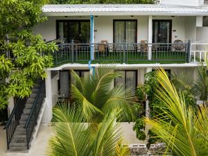 a building with palm trees in front of it at La Palma Suites in Ukulhas