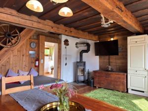 a living room with a table and a couch and a television at Ottls Huette in Sankt Lorenzen ob Murau