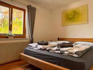 a large bed in a bedroom with a window at Wind Buam Huette in Sankt Lorenzen ob Murau