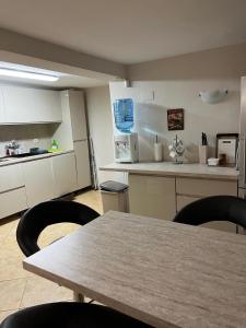 a kitchen with a table and chairs in a room at Villa Tunley in Razvalini Balchikioy