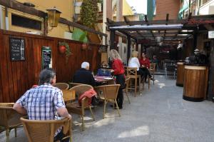 a group of people sitting at tables in a restaurant at Hostal Montsant in Salou