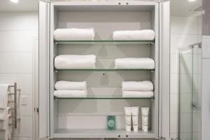 a towel rack with towels in a bathroom at The Edgerley Suites in Auckland +115 photos