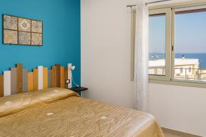 a bedroom with a bed and a large window at RineddaHouse Arenella - Vista Mare Panoramica a Palermo con Parcheggio privato in Palermo