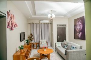 a living room with a couch and a table at T&M Estates Lusaka in Chilanga