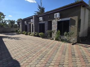 a brick driveway in front of a building at T&M Estates Lusaka in Chilanga
